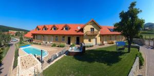 an aerial view of a house with a swimming pool at Penzión Tokaj Ostrožovič in Veľká Tŕňa