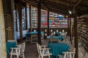 a restaurant with blue tables and chairs in a building at Pelikan Hotel in Mbarara
