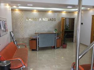 a lobby with a waiting room with a table and chairs at Danista Nomads Tour Hostel in Ulaanbaatar