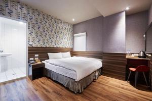 a hotel room with a bed and a shower at Tomorrow Hotel in Taipei