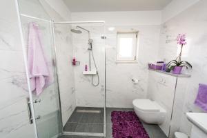 a white bathroom with a shower and a toilet at Apartments Ivica in Split +43 photos
