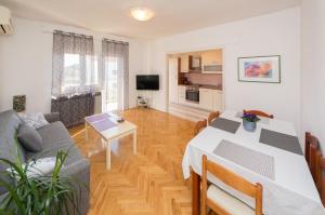 a living room with a table and a couch at Apartments Ivica in Split