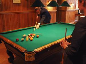a man playing pool on a pool table at Grand Hotel Lund in Lund