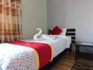 Llit o llits en una habitació de Harvest Moon Guest House