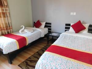Llit o llits en una habitació de Harvest Moon Guest House