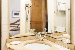 a bathroom with a sink and a mirror at Roccamare Resort - Casa di Levante in Castiglione della Pescaia +21 photos