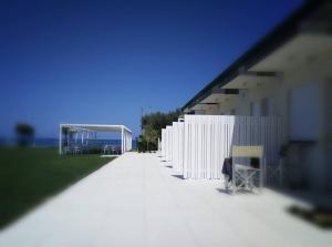 a white fence next to a white building at Agriturismo Frontemare in Giulianova