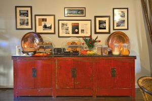 a red wooden cabinet with food on top of it at Tradewinds Carmel in Carmel