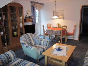 a living room with a table and chairs at Ferienwohnungen Haus Seeblick in Bad Staffelstein