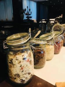 a row of jars filled with different types of food at Hotel Principe di Piemonte in Rimini