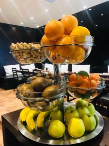 a display of fruit in bowls on a table at Hotel Principe di Piemonte in Rimini