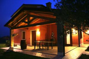a patio with a table and chairs in front of a house at VillaRosa in Santa Lucia di Piave