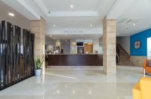 a lobby with a reception desk in a building at Hotel Orosol in San Antonio