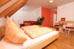 a bed with pillows on it in a room at Gasthof-Pension Brauner Hirsch in Alfeld - Mittelfranken in Alfeld