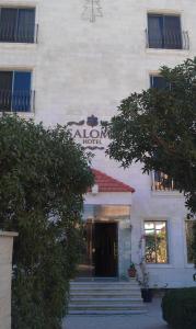 a building with a sign on the front of it at Salome Hotel in Madaba