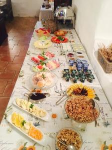 a long table with many plates of food on it at Dvůr Olšiny -Hotel and Horse-riding in Karviná