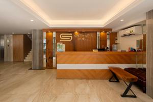 a lobby of a hotel with a bench and a counter at Green Star Hotel in Ho Chi Minh City