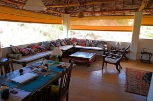a living room with a couch and a table at Deuli House in Shela