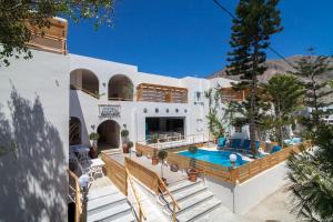 a villa with a swimming pool and a house at Amaryllis Hotel in Perissa