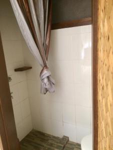 a bathroom with a shower with a curtain at Le Cou de Tou Village Resort in San Vicente