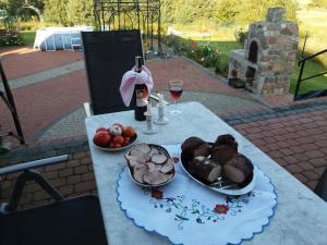 a table with a plate of food and a bottle of wine at Apartamentypomorze in Białogóra