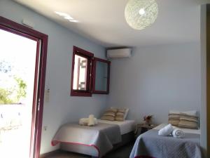 Postel nebo postele na pokoji v ubytování Mikros Gialos Apartments