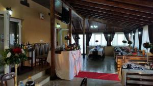 a dining room with tables and chairs in a restaurant at Royal 60 in Oşorheiu