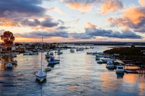 a group of boats docked in a river at sunset at Relax Apartment Costa Esuri in Ayamonte