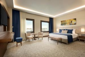 a hotel room with a bed and a desk at Ramada by Wyndham Yalova in Yalova +107 photos