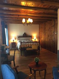 a bedroom with a bed and a table and chairs at El Barondillo in Rascafría