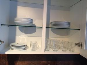 a glass cabinet with plates and glasses in it at Big and Beautiful in Hannover +12 photos