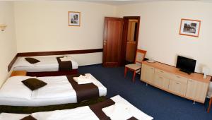 Posteľ alebo postele v izbe v ubytovaní Garni Hotel Tatramonti