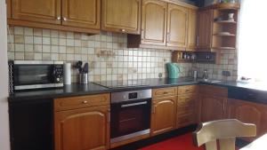 a kitchen with wooden cabinets and a black counter top at Ferienhaus Holiday in Radstadt