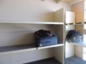 a room with shelves with luggage and bags at Apart Las Lenas in Las Lenas
