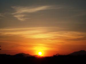 a sunset with the sun in the sky at Anthia Apartments in Marmari