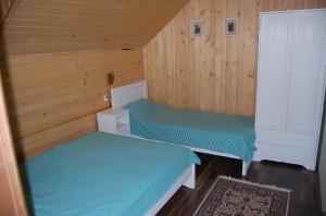 Un pat sau paturi într-o cameră la Vila Runolist