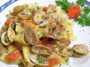 a plate of pasta with mushrooms and vegetables at Hotel Ristorante Borgo La Tana in Maratea