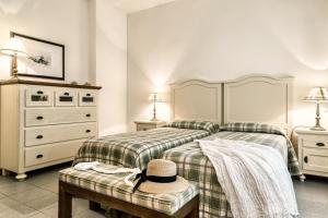 Postel nebo postele na pokoji v ubytování Roccamare Resort - Ville e Appartamenti
