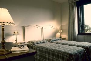 Postel nebo postele na pokoji v ubytování Roccamare Resort - Ville e Appartamenti