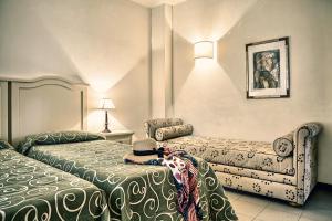 Krevet ili kreveti u jedinici u objektu Roccamare Resort - Ville e Appartamenti