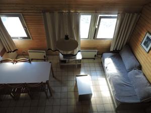 a living room with a couch and a table at Apart Las Lenas in Las Lenas +49 photos