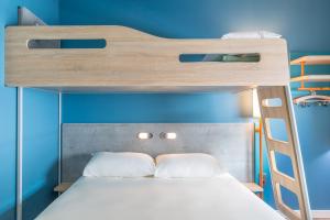 a bedroom with a bunk bed with a ladder at ibis budget Geneve Palexpo Aeroport in Geneva +54 photos
