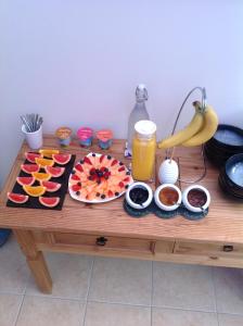 
a table topped with cupcakes and bowls of fruit at Bed and Breakfast at 4 in Thurso
