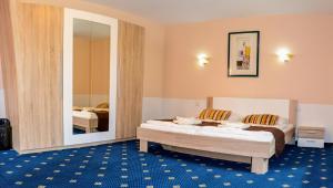 Posteľ alebo postele v izbe v ubytovaní Garni Hotel Tatramonti