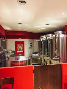 a large kitchen with stainless steel appliances in a restaurant at De La Tour in Tirano