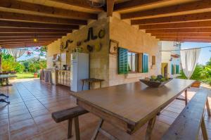 a kitchen and dining room with a wooden table at Can Rius in Muro