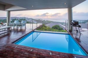 a house with a swimming pool on a deck at 1 Ezulweni in Ballito