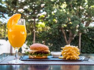 a sandwich and french fries and a glass of orange juice at Topazio Vibe Beach Hotel & Apartments - Adults Friendly in Albufeira
