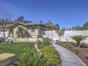 a house with a white fence in a yard at Sweet Wildomar Retreat in Wildomar