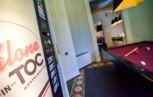 a room with a pool table and a game machine at Toc Hostel Madrid in Madrid +126 photos
